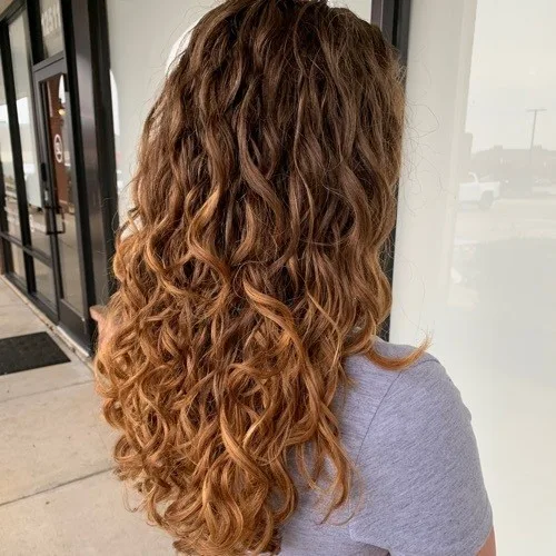 Client with copper spiral curls after a curly cut at Curls Done Wright
