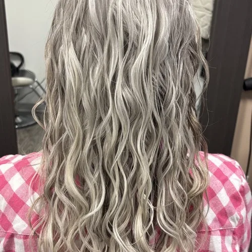 Client with silver blonde waves after a curly cut at Curls Done Wright
